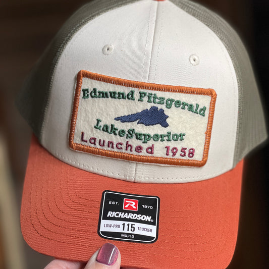 hand holding edmund fitzgerald trucker hat