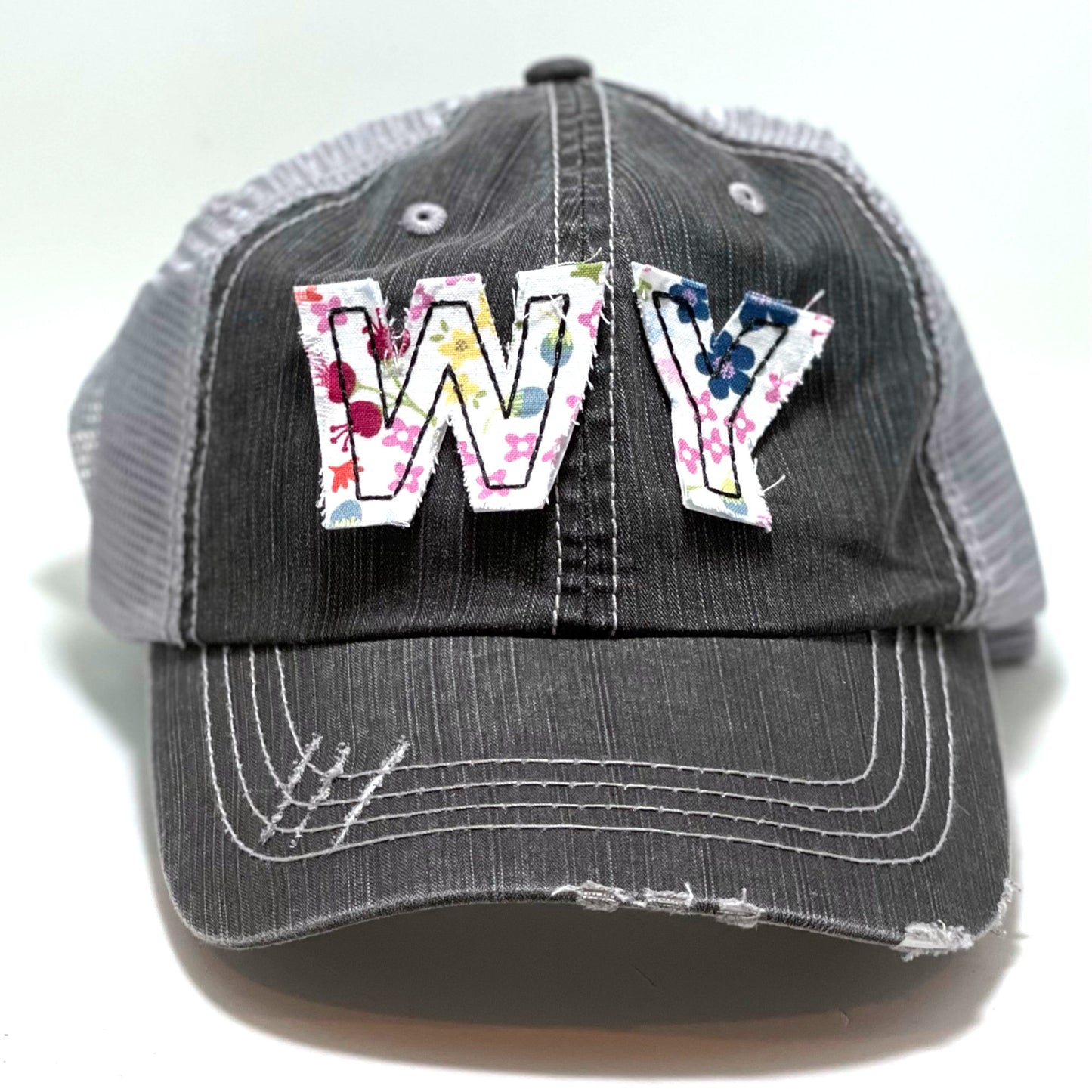 gray distressed trucker hat with gray floral fabric state of Wyoming